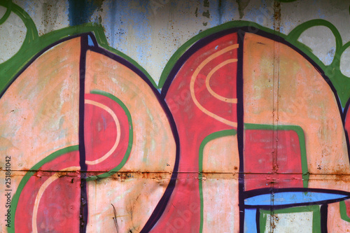 Part of graffiti on metal hangar in black and white.