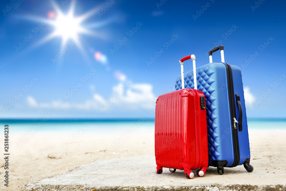 Summer suitcase on beach and sea landscape Summer suitcase on beach and sea landscape