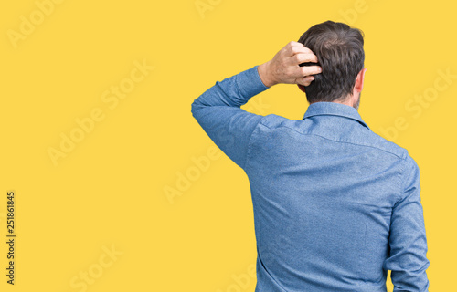 Tableau sur toile Handsome middle age elegant senior man over isolated background Backwards thinki