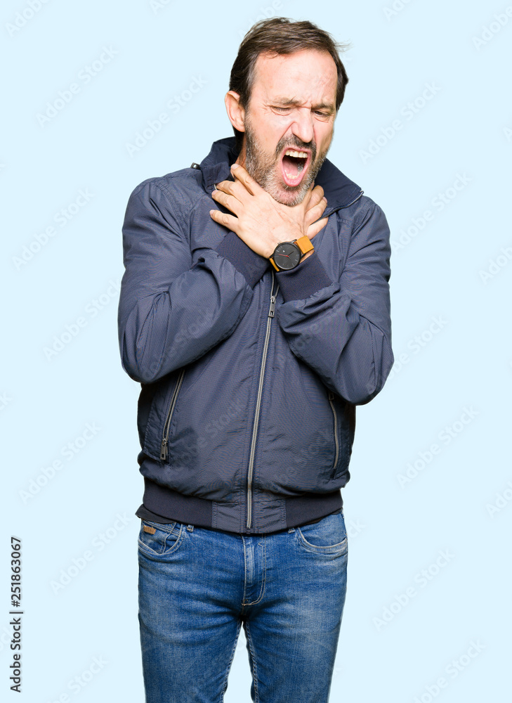 Middle age handsome man wearing a jacket shouting and suffocate because painful strangle. Health problem. Asphyxiate and suicide concept. Middle age handsome man wearing a jacket shouting and suffocate because painful strangle. Health problem. Asphyxiate and suicide concept.