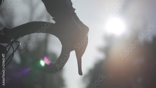 Handlebar Bike At Sunrise.Cyclist Hold Road Bike Handlebar.Biker Placing Hands On Handlebar Grips.Bicycle Handlebar And Hand Detail. Bicycle Handlebar Close-Up.Hand Grips Bike Handlebar, Closeup.  photo