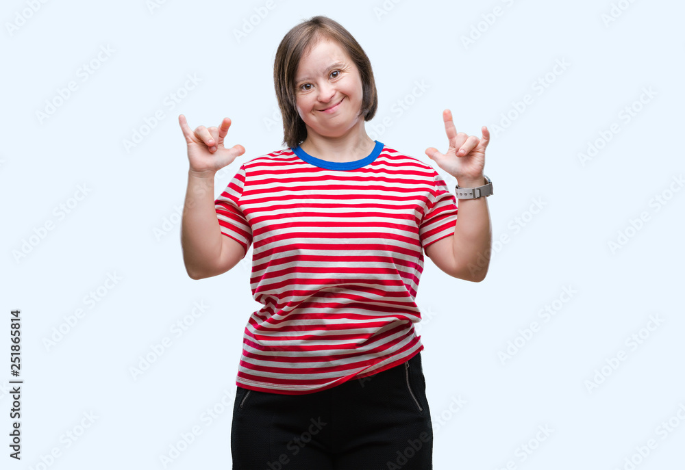 Young adult woman with down syndrome over isolated background shouting with crazy expression doing rock symbol with hands up. Music star. Heavy concept. Young adult woman with down syndrome over isolated background shouting with crazy expression doing rock symbol with hands up. Music star. Heavy concept.