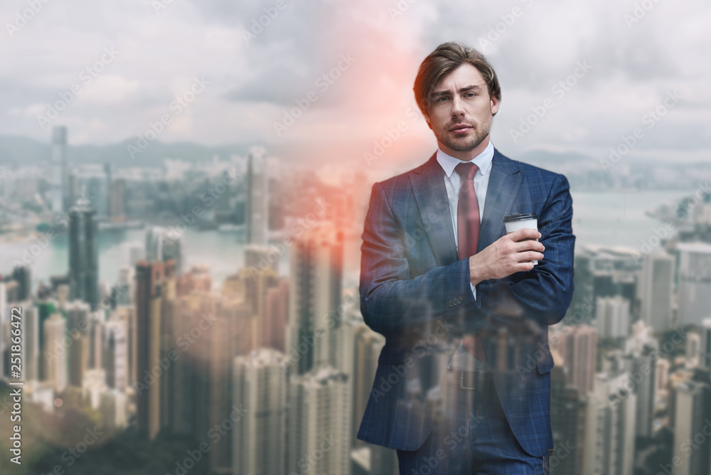 Enjoing coffee break. Portrait of confident and attracrive businessman holding cup of coffee while standing against of cityscape background Enjoing coffee break. Portrait of confident and attracrive businessman holding cup of coffee while standing against of cityscape background