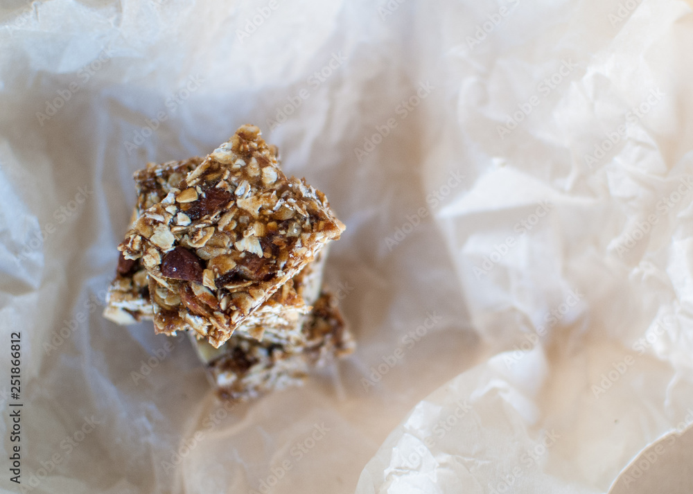 Healthy bars with almonds, oats and dates fruits on kraft background, with copy space. Healthy bars with almonds, oats and dates fruits on kraft background, with copy space.