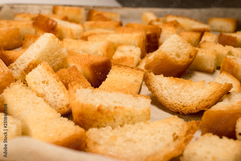 Fresh fried (baked) crunchy crispy golden croutons (traditional snack like cracker) from white bread Fresh fried (baked) crunchy crispy golden croutons (traditional snack like cracker) from white bread