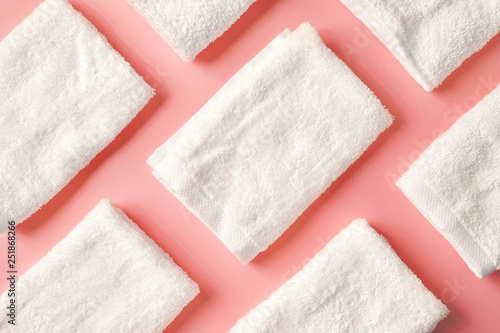 White spa towels on pink, from above