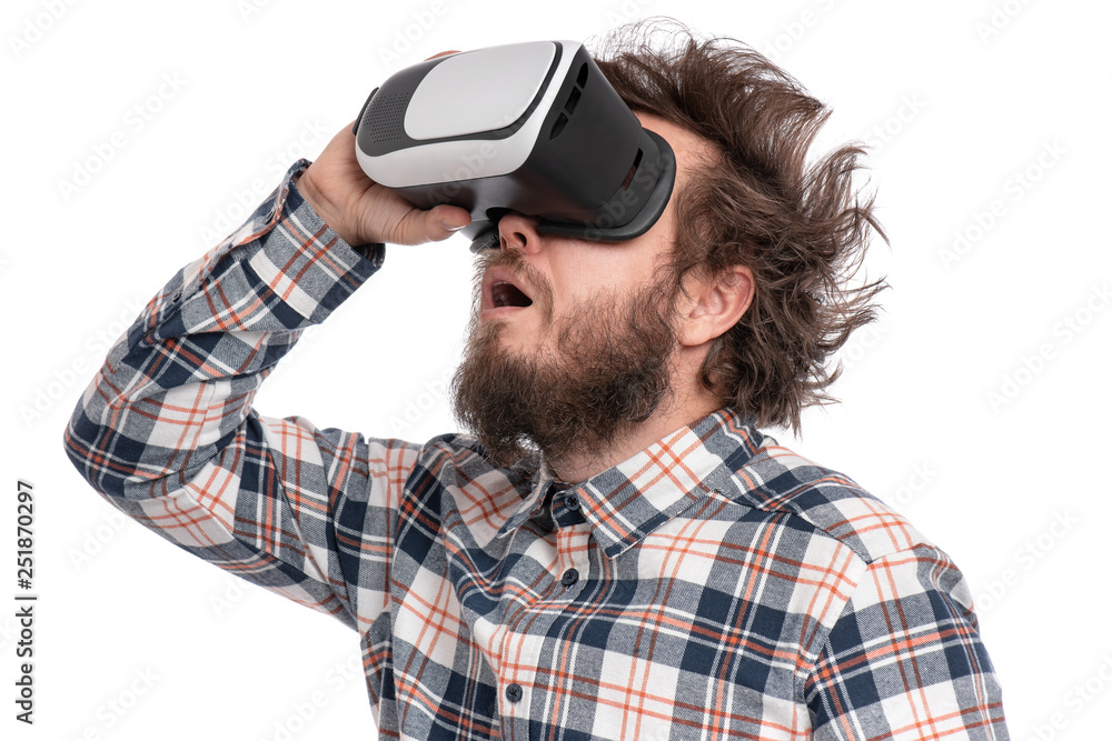 Crazy bearded Man in plaid shirt with funny Haircut wearing virtual reality helmet, isolated on white background. Portrait of funny man using VR goggles. Crazy bearded Man in plaid shirt with funny Haircut wearing virtual reality helmet, isolated on white background. Portrait of funny man using VR goggles.