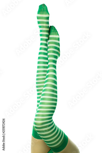 Sexy female legs in green striped stockings. Leprechaun girl  isolated on white