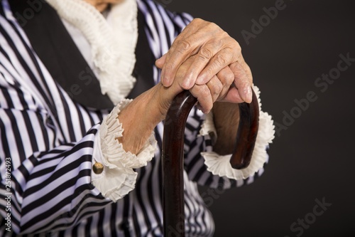 Old grandma in a white-black striped jacket