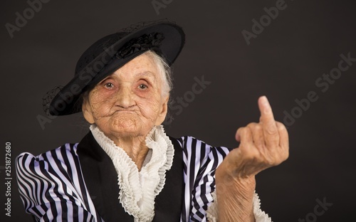 Old grandma in a white-black striped jacket