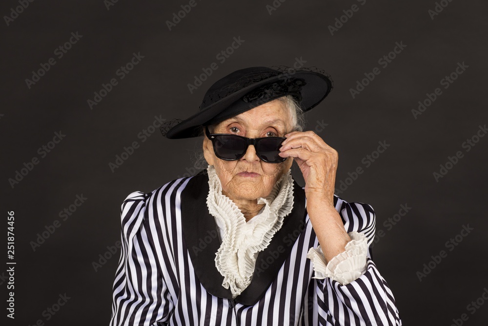 Old grandma in a white-black striped jacket Old grandma in a white-black striped jacket