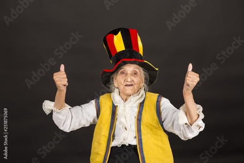 vintage old woman wearing cylinder and a yellow vest