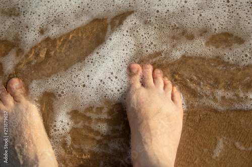 Closeup of feet in the water
