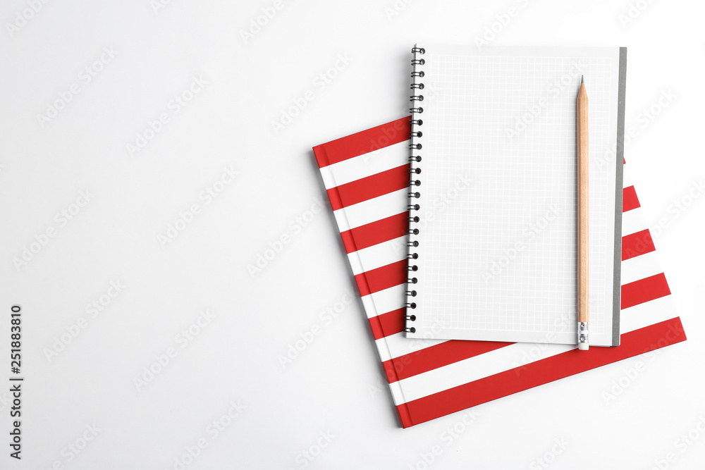 Copybooks and pencil on white background, top view Copybooks and pencil on white background, top view