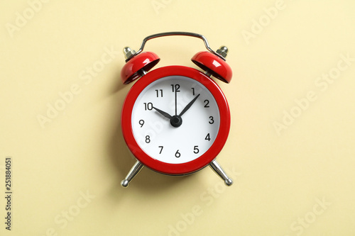 Retro alarm clock on color background, space for text