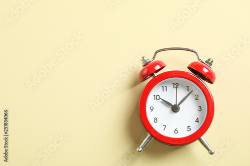 Retro alarm clock on color background, space for text