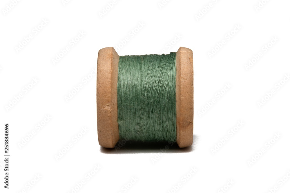 Wooden coil with thread on a white isolated background Wooden coil with thread on a white isolated background