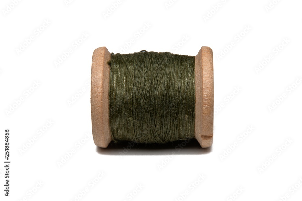 Wooden coil with thread on a white isolated background Wooden coil with thread on a white isolated background