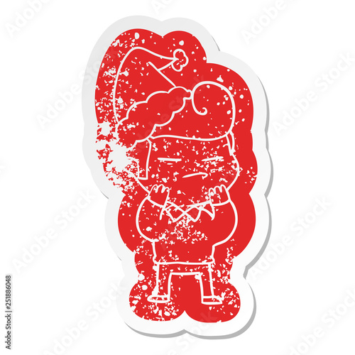 cartoon distressed sticker of a cool guy with fashion hair cut wearing santa hat