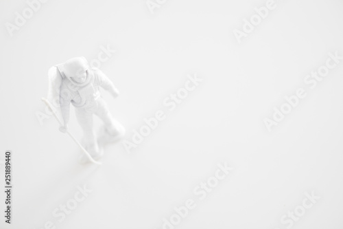 Fototapeta Naklejka Na Ścianę i Meble -  Lone Generic White Astronaut Figurine with American Flag in dramatic lighting