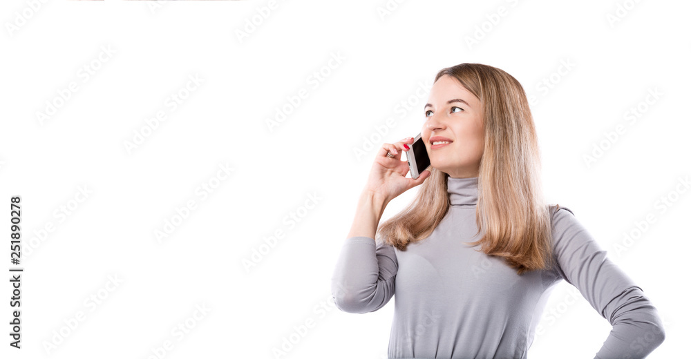 The theme of a business woman and telephone conversations. Beautiful young caucasian woman uses a smartphone handset to call in formal clothes on a white isolate background The theme of a business woman and telephone conversations. Beautiful young caucasian woman uses a smartphone handset to call in formal clothes on a white isolate background