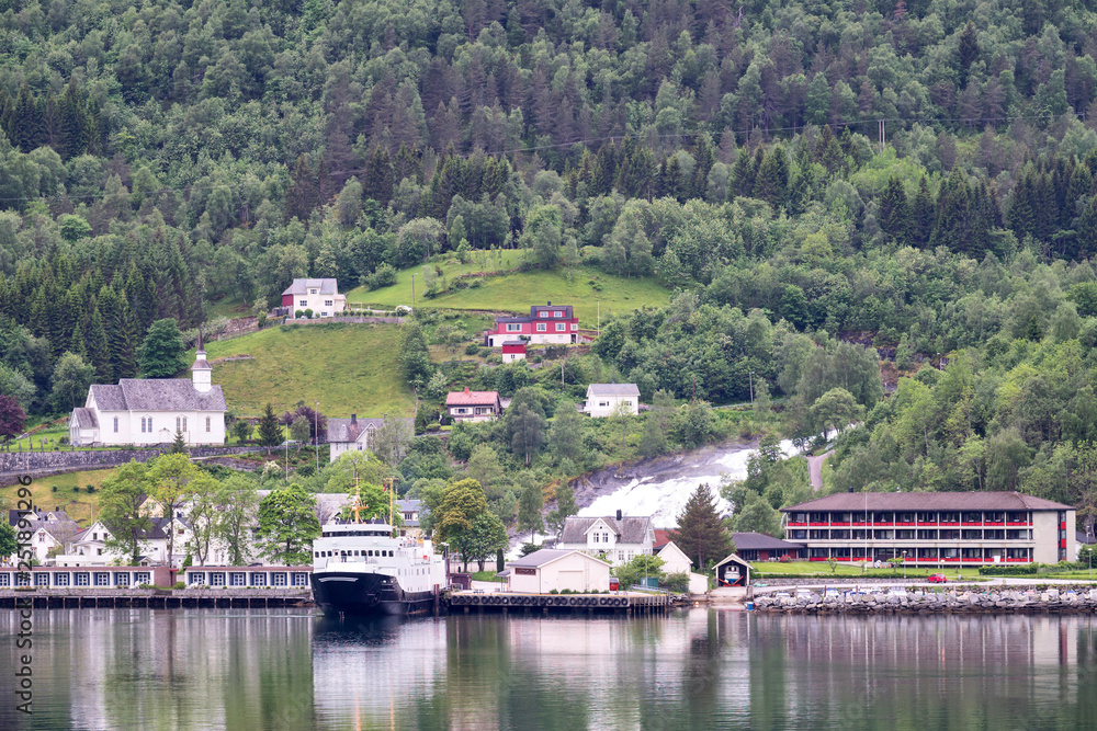 View of Hellesylt, Norway. Hellesylt lies at the head of the Sunnylvsfjorden, which is a branch of the Storfjorden, and which the more famous Geirangerfjorden in turn branches off nearby.