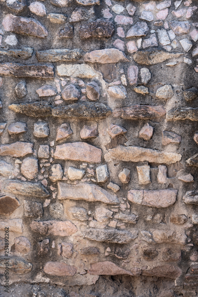 Stone rocks used to create a subtle pinkish wall. Old wall detail with rich textures Stone rocks used to create a subtle pinkish wall. Old wall detail with rich textures