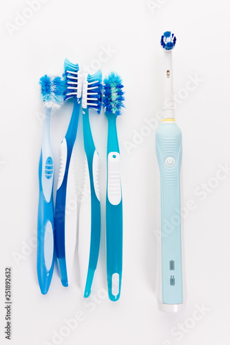Manual Regular Toothbrush Against Modern Electric Toothbrush. Isolated on White Background