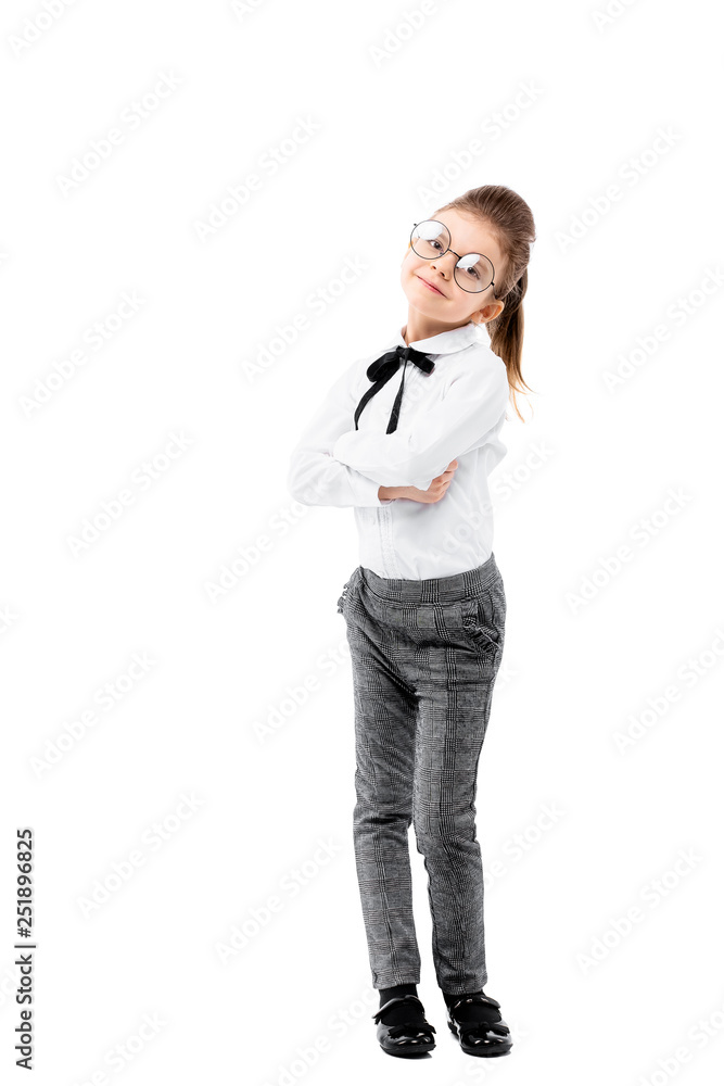 Beautiful little girl dressed like a School girl - in white shirt and gray pants, rounded glasses standing near white wall and posing like model. Beautiful little girl dressed like a School girl - in white shirt and gray pants, rounded glasses standing near white wall and posing like model.