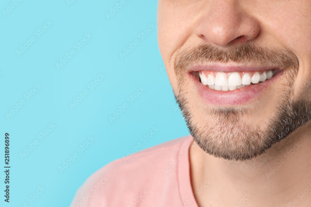 Smiling man with perfect teeth on color background, closeup. Space for text Smiling man with perfect teeth on color background, closeup. Space for text