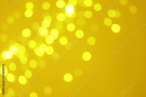 Blurred view of shiny gold lights. Bokeh effect