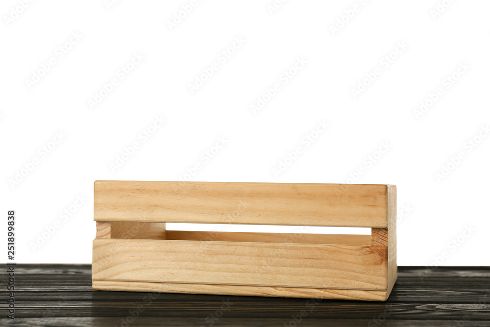 Empty rustic wooden crate on table against white background