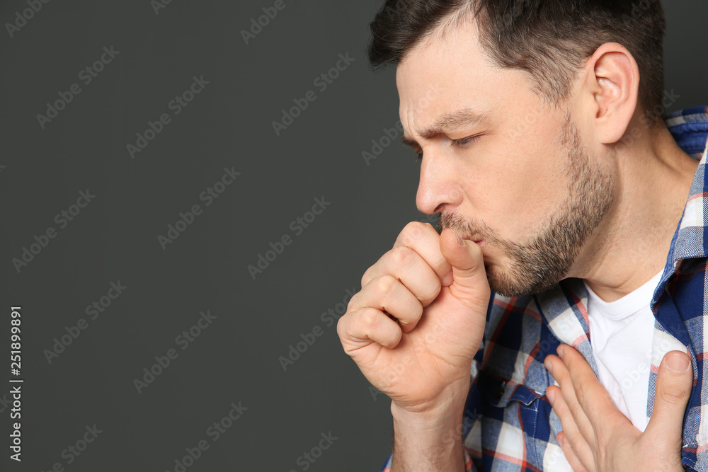 Mature man suffering from cough on dark background. Space for text Mature man suffering from cough on dark background. Space for text