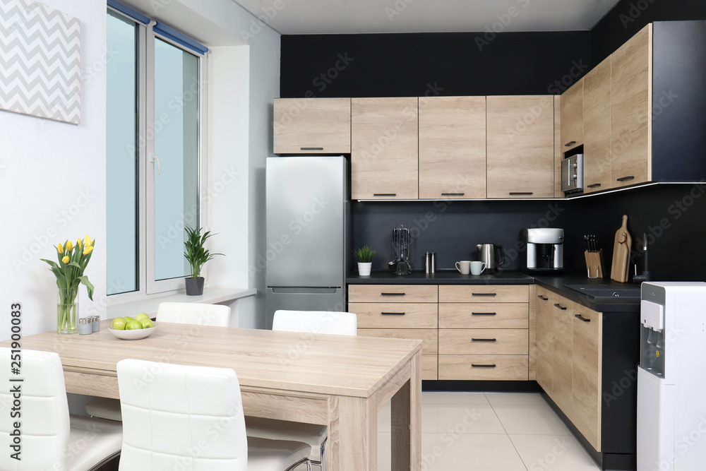 Cozy modern kitchen interior with new furniture and appliances Cozy modern kitchen interior with new furniture and appliances
