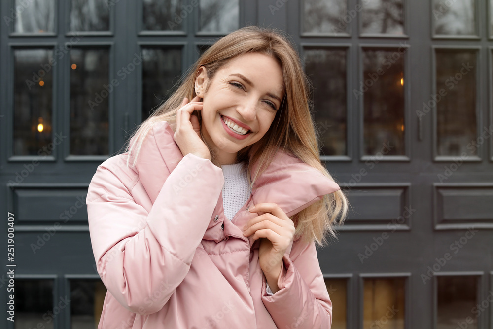 Happy young woman in warm jacket outdoors Happy young woman in warm jacket outdoors