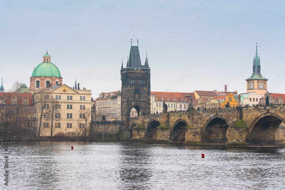 Prague, Czech republic. Famous historical Charles bridge with old town tower that crosses the Vltava river in old town. Czech legend has it that construction began on 9 July 1357 