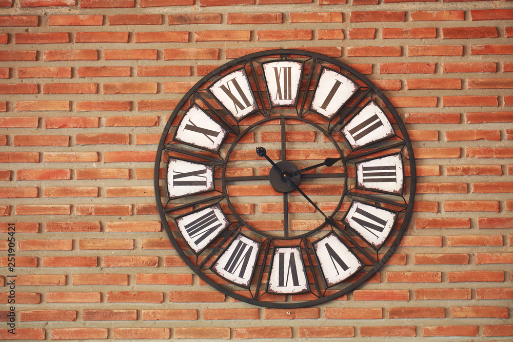 Classic clock on concrete wall background, decoration wall clock hanging on old clock