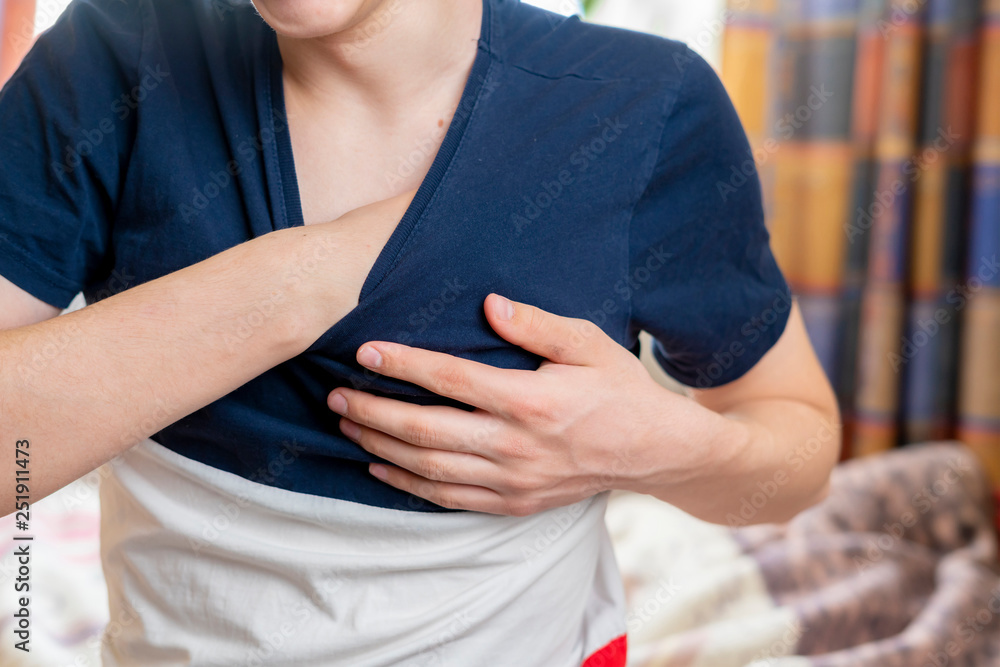 male having heart attack and hold his hand on chest b male having heart attack and hold his hand on chest b