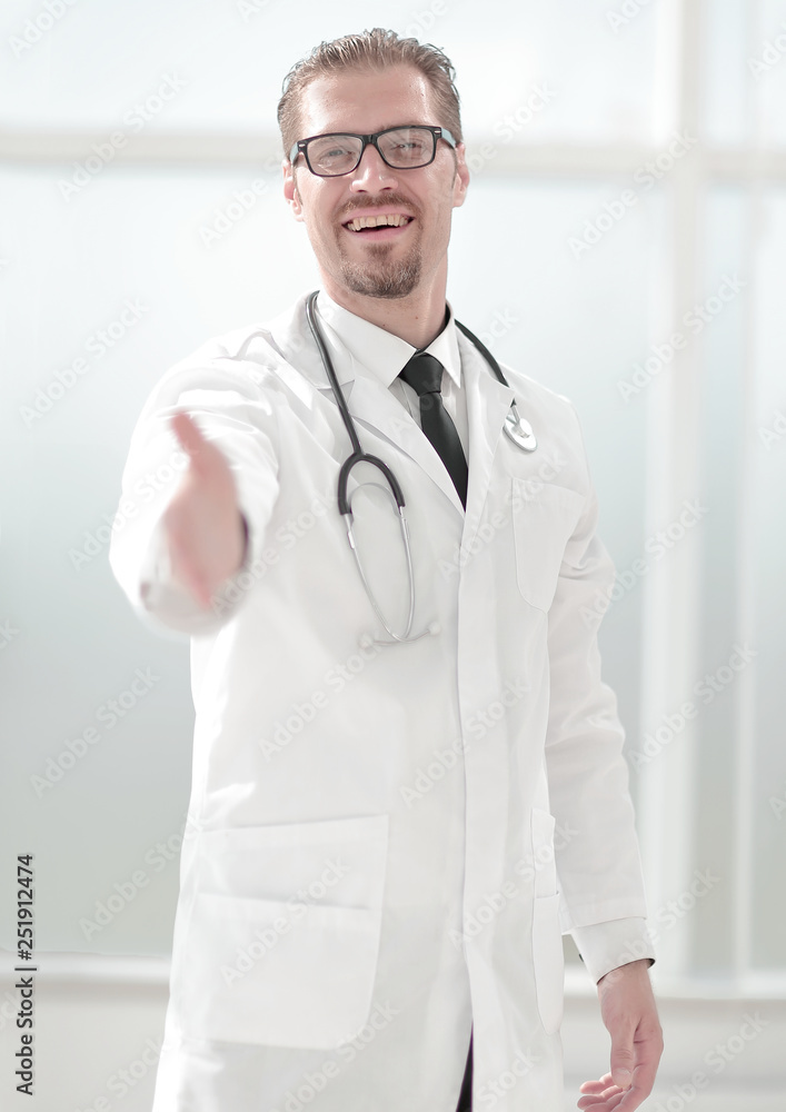 friendly doctor extending his hand for greeting friendly doctor extending his hand for greeting