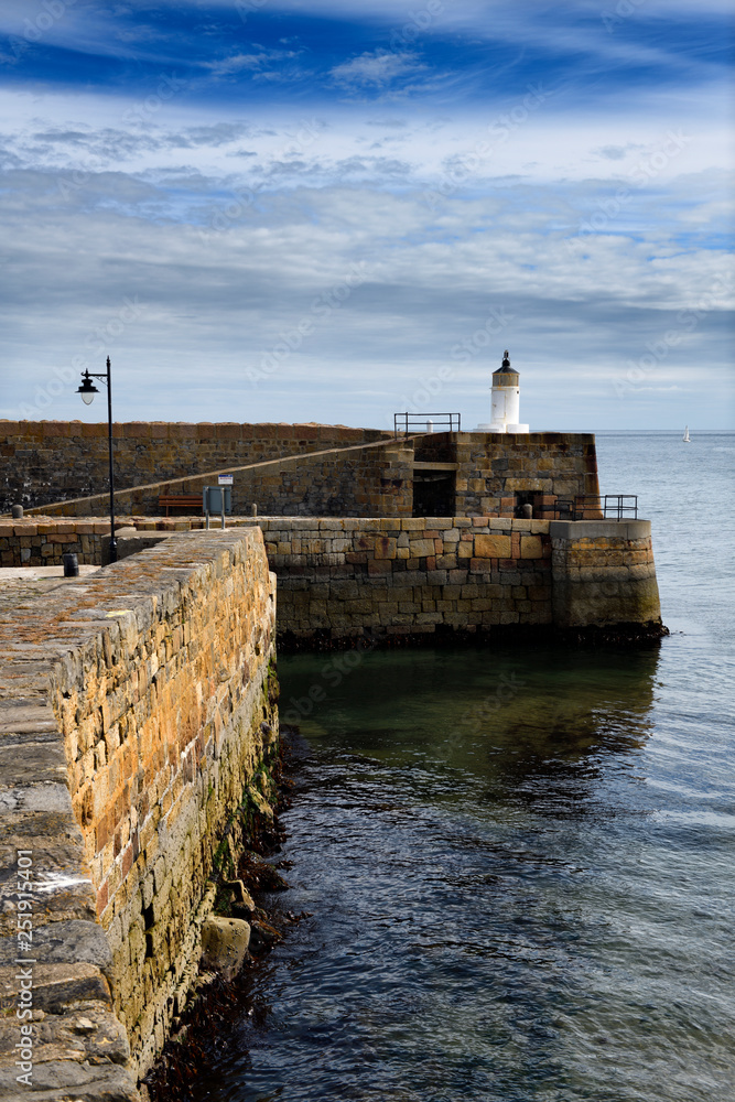 Lighthouse on stone walls of Banff Harbour on Banff Bay Moray Firth Aberdeenshire Scotland UK