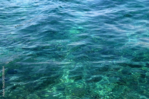 Sunlight reflects on a sea surface. Beautiful clear water. Selective focus.