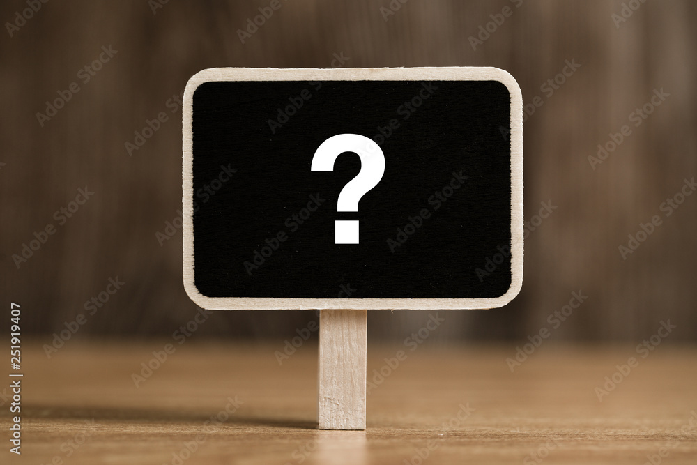 White chalk question mark on the black sign board. White chalk question mark on the black sign board.