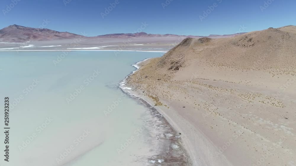 Aerial drone scene of Diamante Lagoon in Galan volcano at Antofagasta de la Sierra, Catamarca Province, Puna Atacama, Argentina. Camera moving forwards over salty cracker water.
