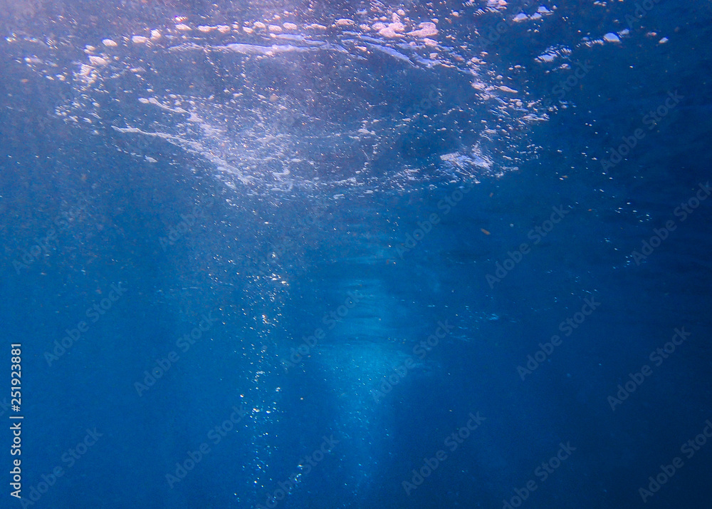 Scuba diving bubbles with sunrays coming down through them.