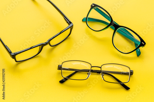 Accessories for eyes. Glasses with transparent lenses and different frames on yellow background
