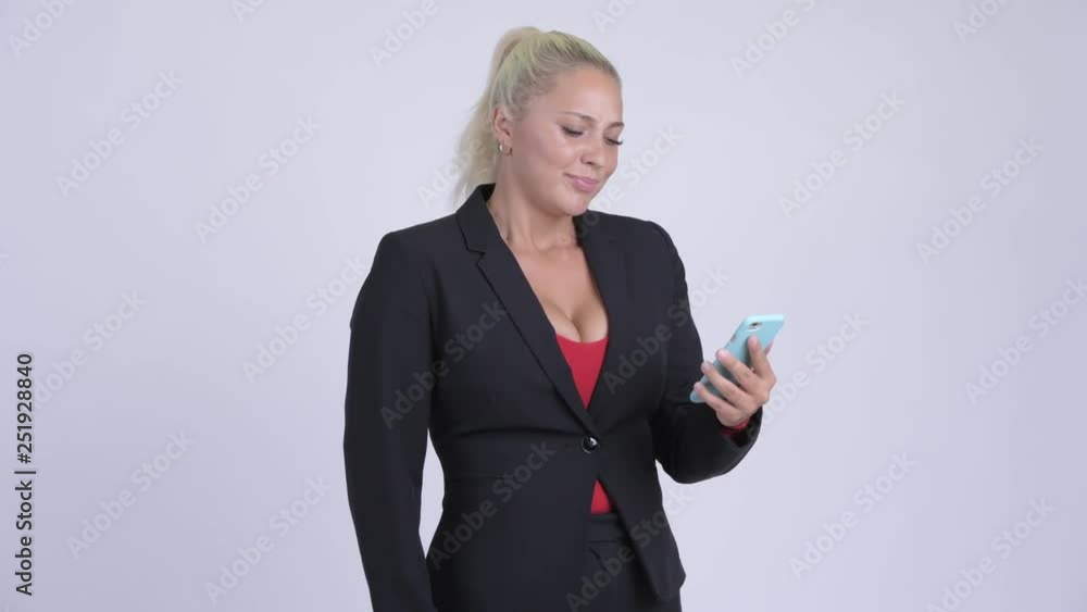 Young stressed blonde businesswoman using phone and getting bad news Young stressed blonde businesswoman using phone and getting bad news