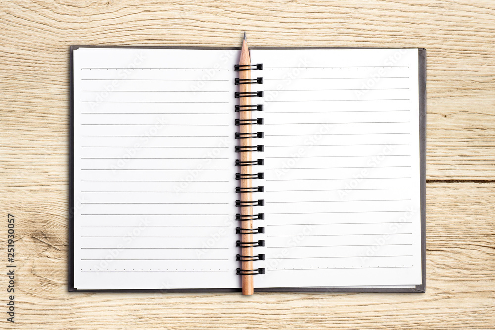 Open blank notebook and pencil on wood background. Open blank notebook and pencil on wood background.
