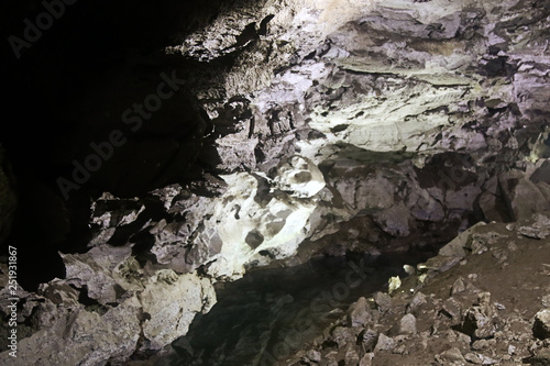 Half-filled with rock and clay natural cave. photo