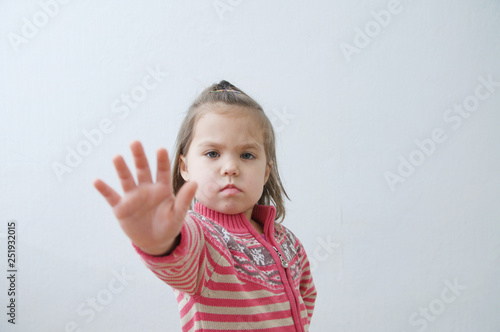 stop sign, toddlers palm saying stop with hands in front of himself. suspend of constraint on children. Kids protection.