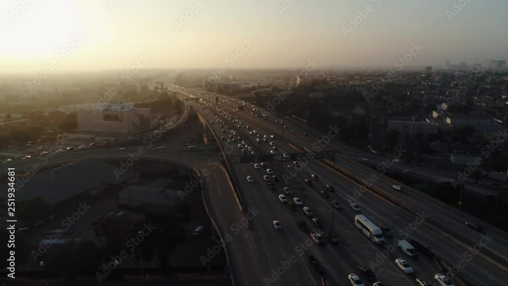 Above the highway in heavy traffic, sunset, cinematic aerial shot Above the highway in heavy traffic, sunset, cinematic aerial shot